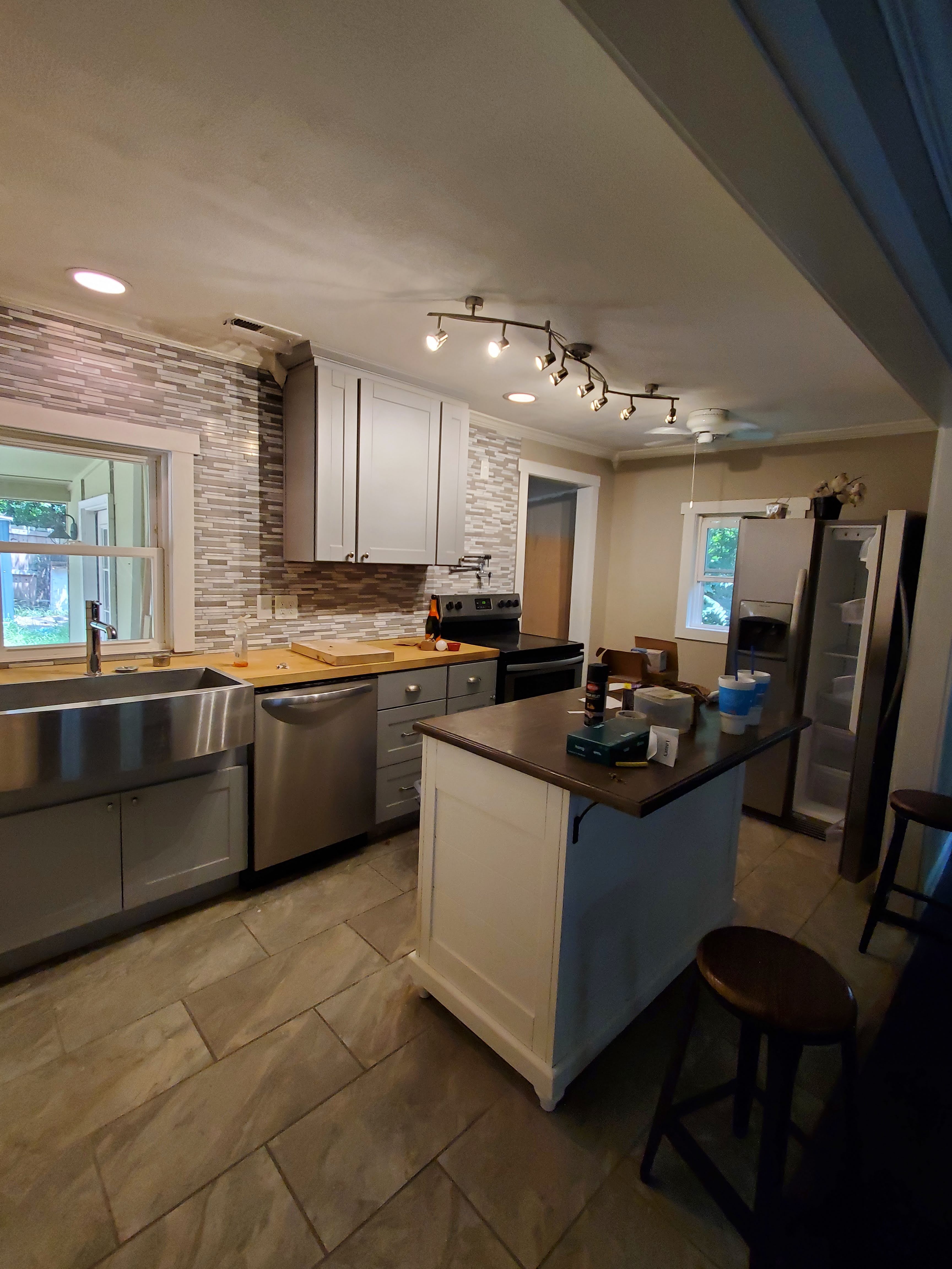 Updated kitchen with modern appliances and white cabinets