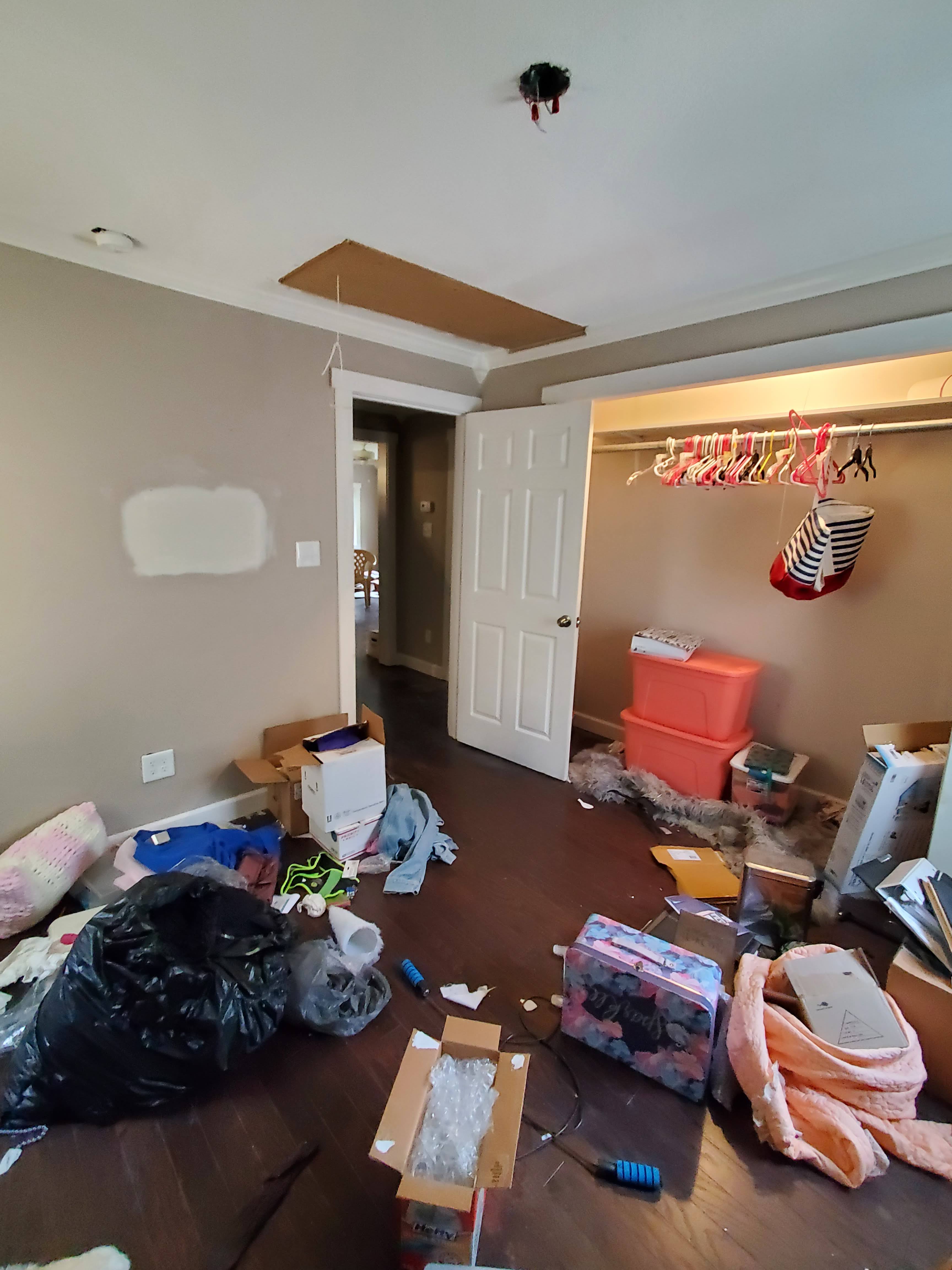 Bedroom with personal belongings and clothing