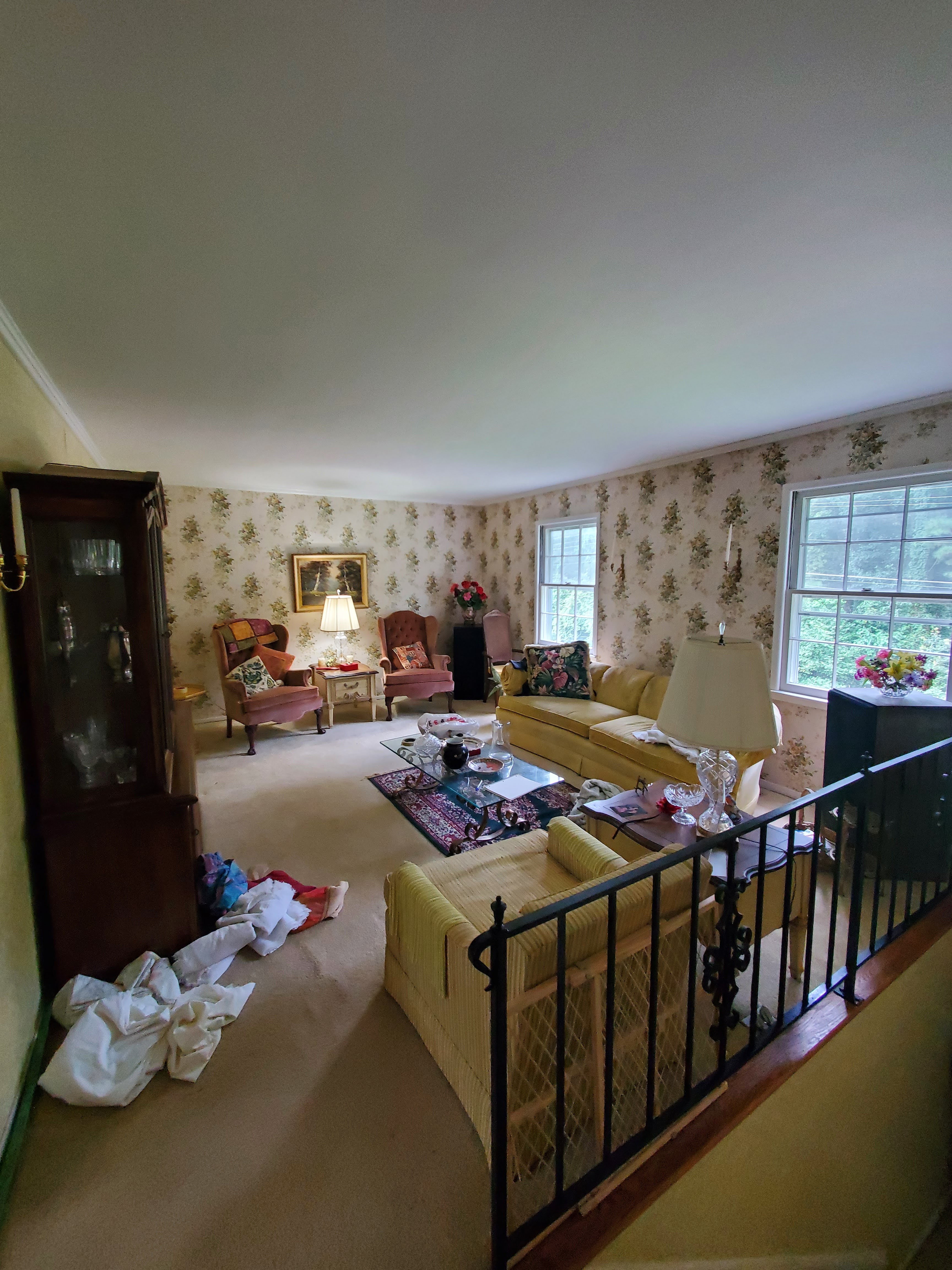 Upstairs living room with yellow couch and floral wallpaper