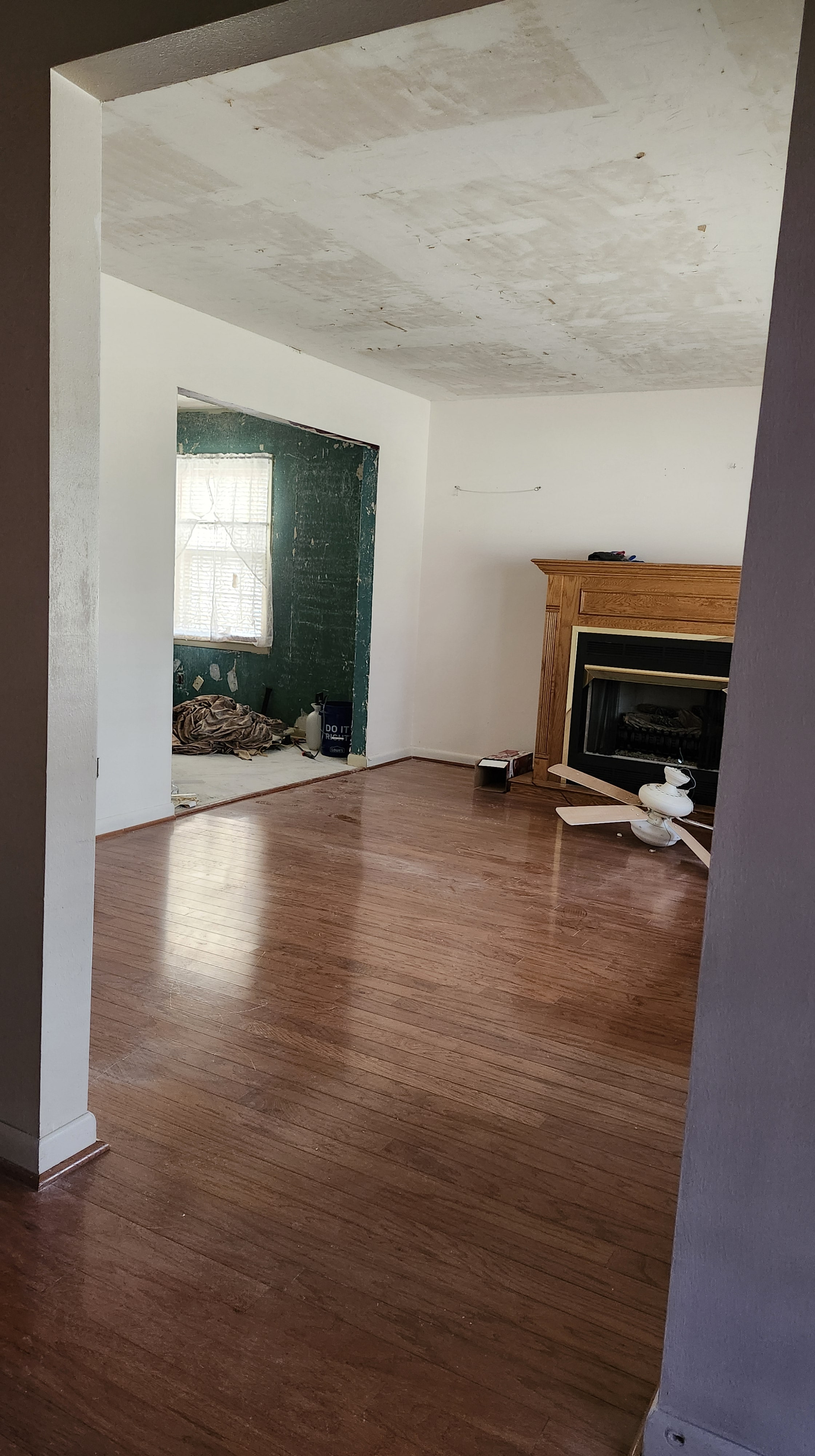 Living room showing hardwood floors and ceiling damage