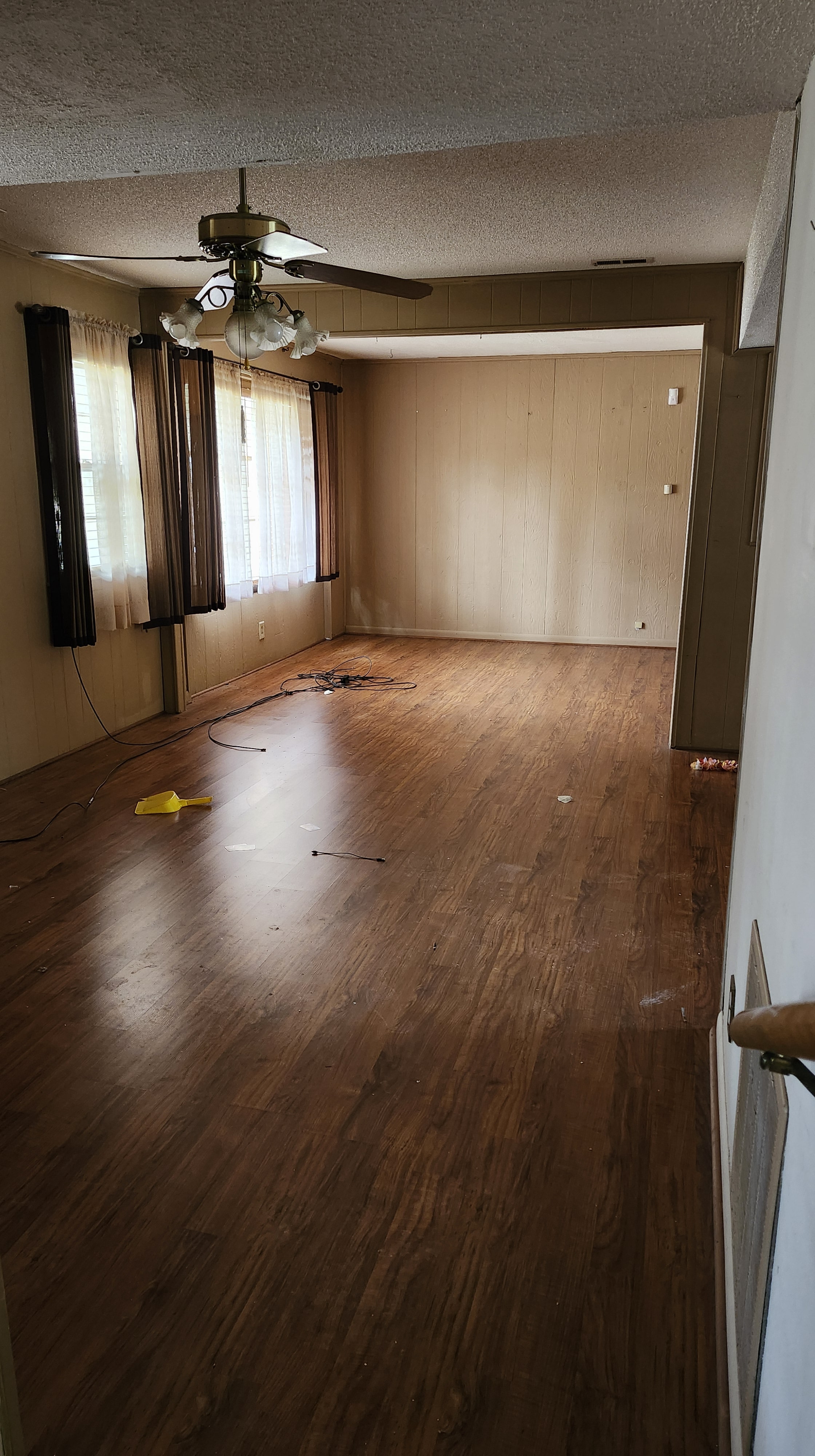 Bedroom with wood paneling and hardwood floors