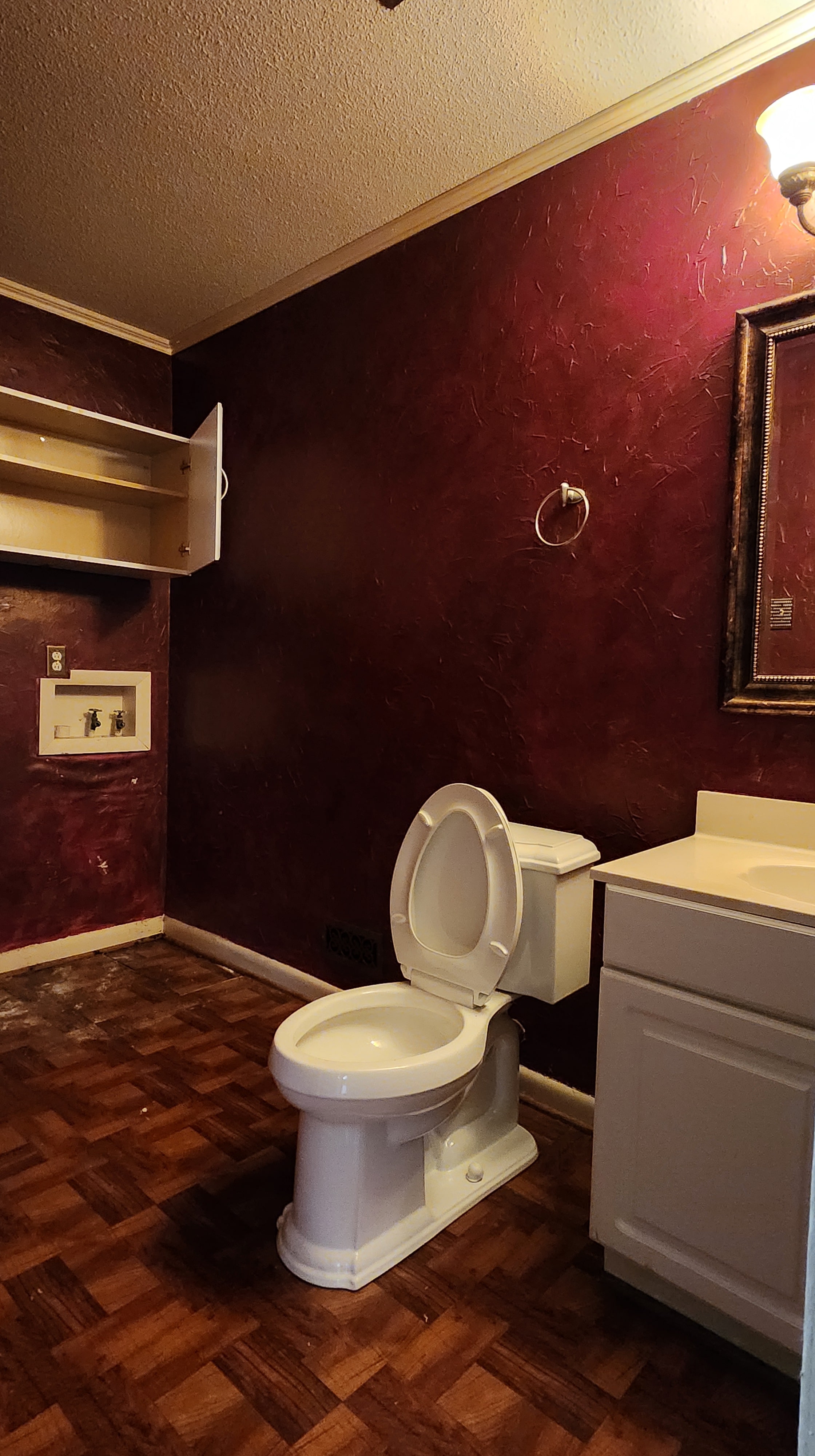Bathroom with red walls and hardwood flooring